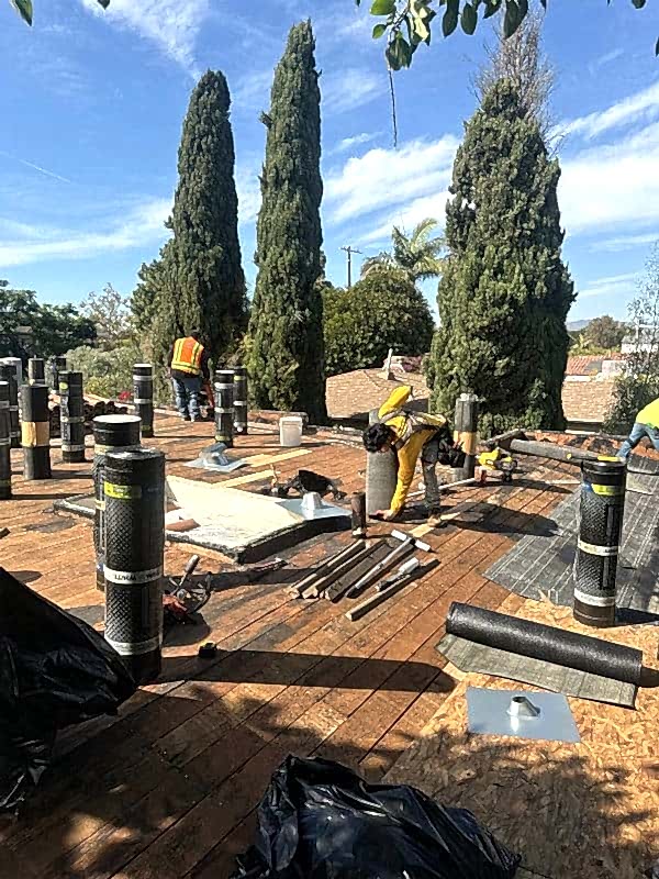 Roof flashing and underlayment materials laid out on a roof deck