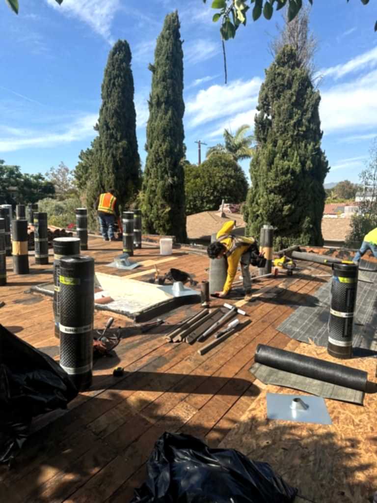 Roof Repair & Construction crew replacing roof flashing on a Southern California home
