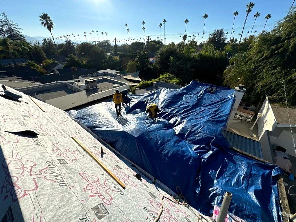Roof Repair & Construction crew tarping a leaking Southern California roof