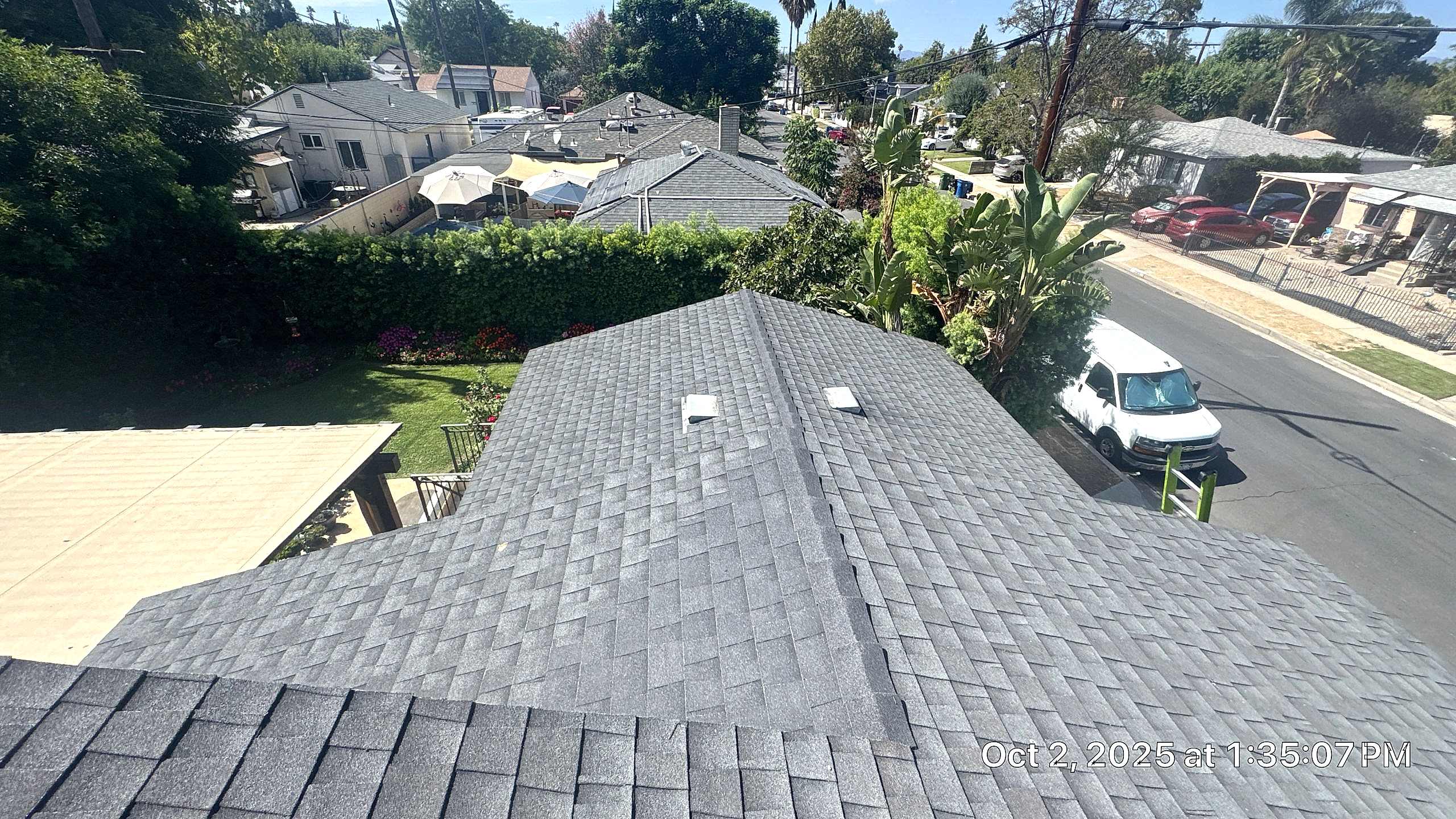 View of residential rooftops and backyard garden.