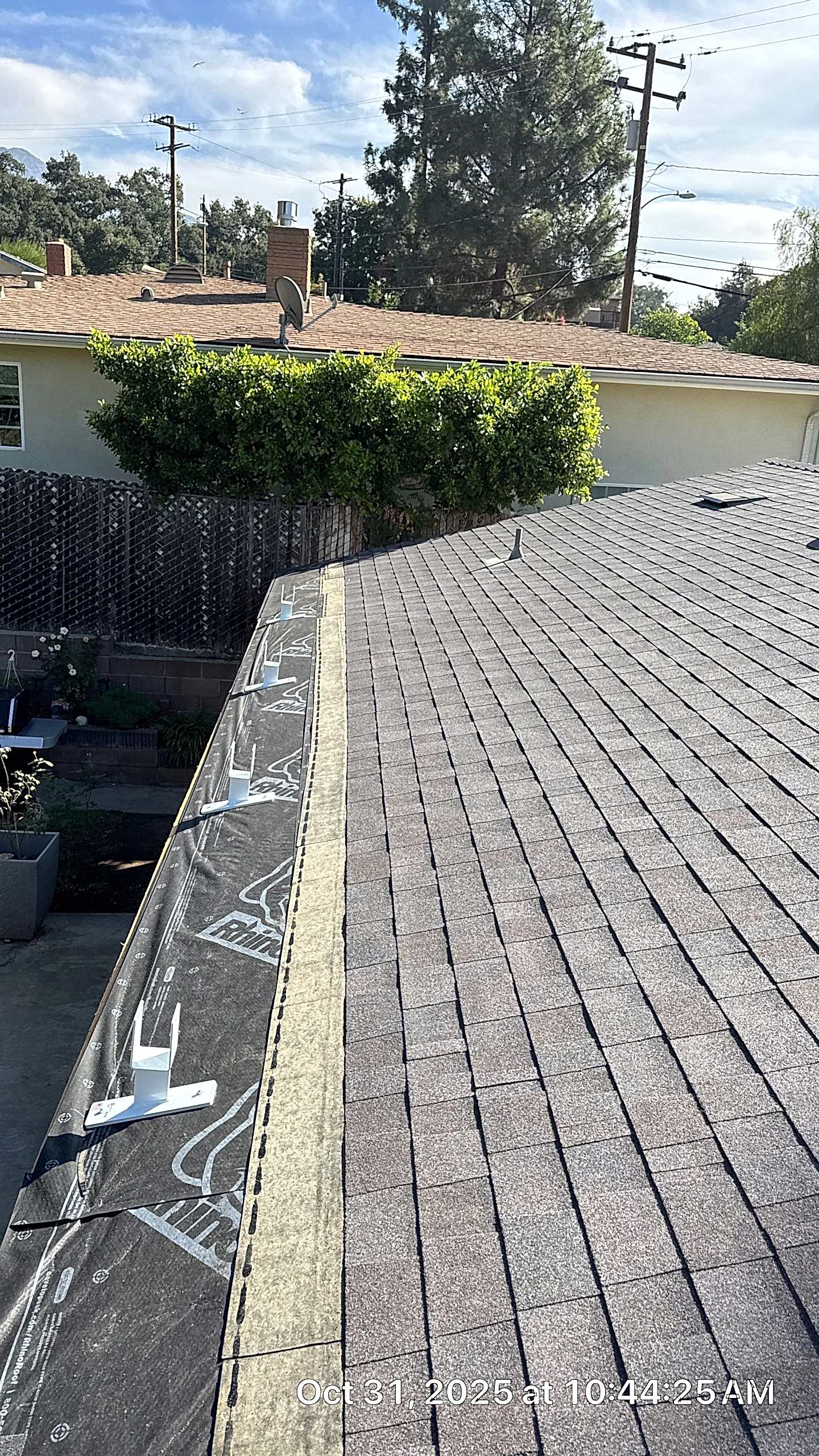 Rooftop view showing roof shingles installation.