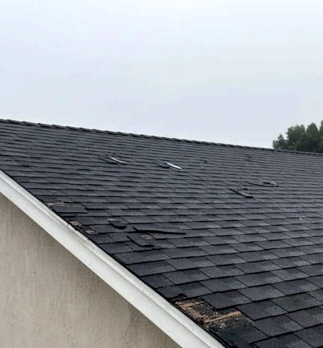 Storm damaged shingle roof needing emergency repair