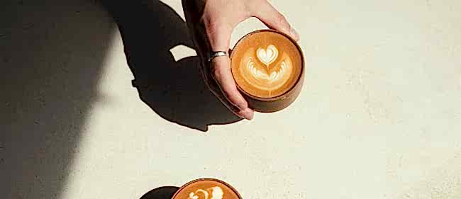 Flat white held by a hand